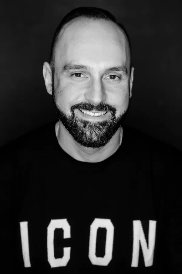 Headshot of Mario Thomas wearing a Givenchy Icon jumper