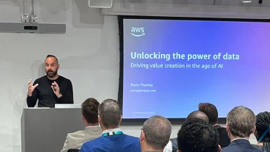 Mario Thomas at the lectern presenting Unlocking the Power of Data to private equity executives at AWS in London