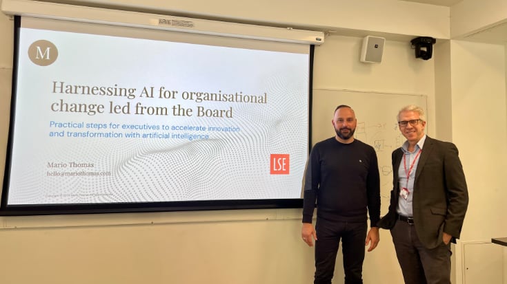 Mario Thomas and Kenneth Benoit standing in front of a display screen at the London School of Economics