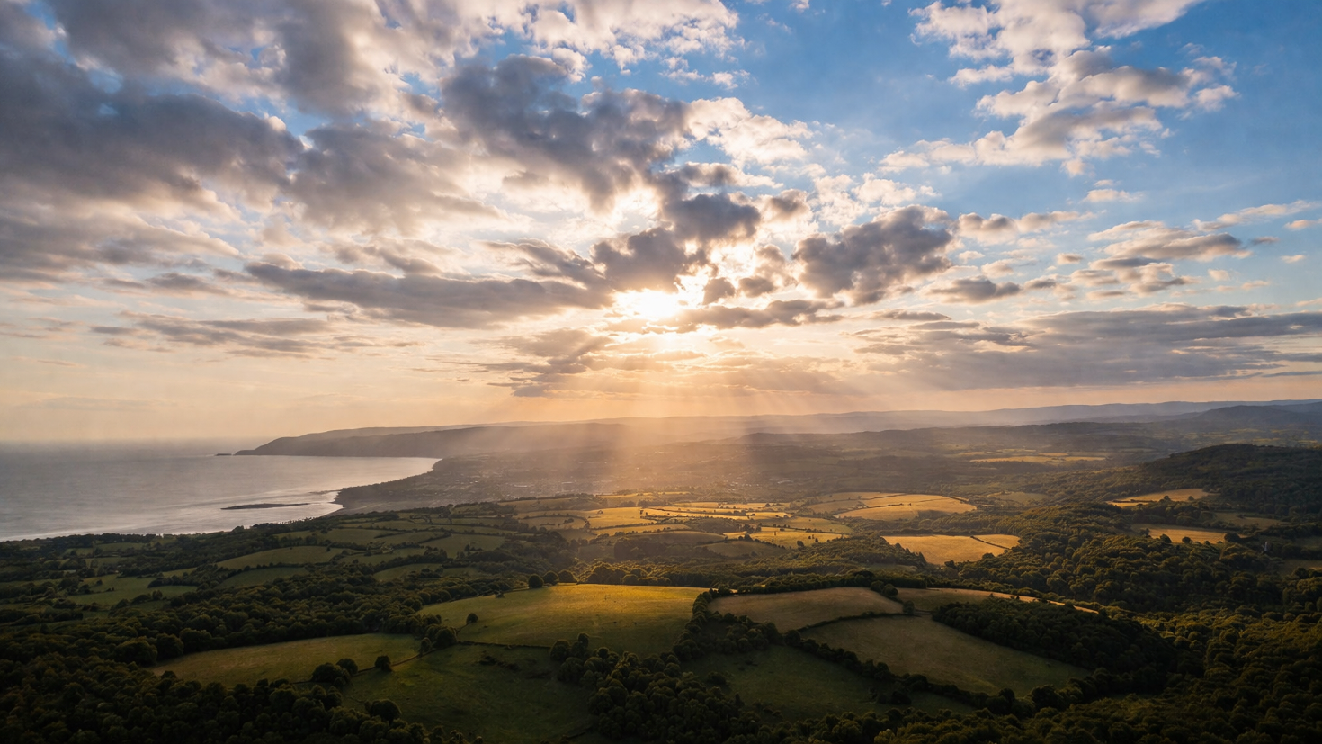 Aerial view of a landscape as clouds gradually clear, with sunlight revealing the underlying terrain, representing how a board-level diagnostic cuts through activity metrics to expose the organisation's true AI position