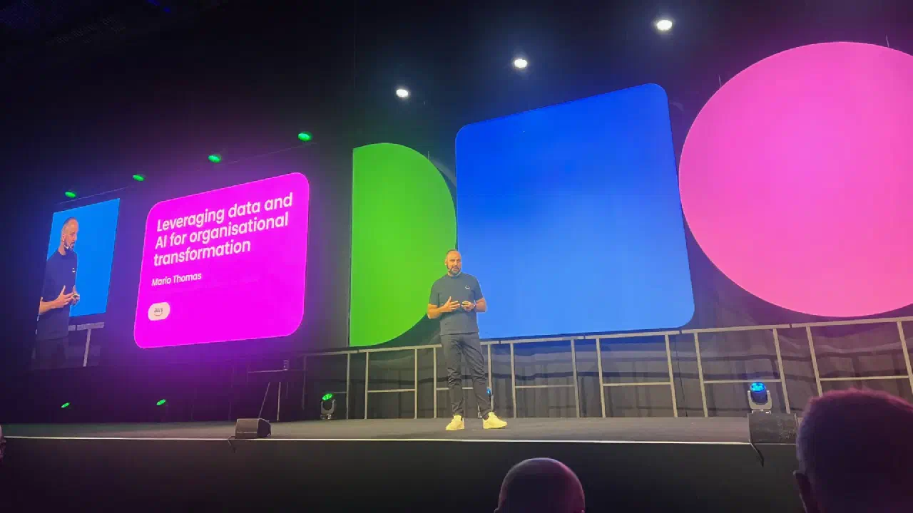 Mario Thomas presenting Leveraging Data and AI for Organisational Transformation on a conference stage